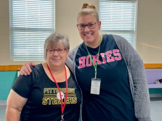 Two Mayflower staff members posing together indoors